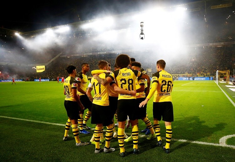 Borussia Dortmund players celebrate after beating Bayern Munich in recent Bundesliga match