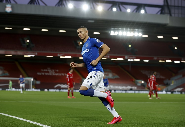 Richarlison celebrates after sending the ball past Alisson to give Everton an early lead in the Premier League